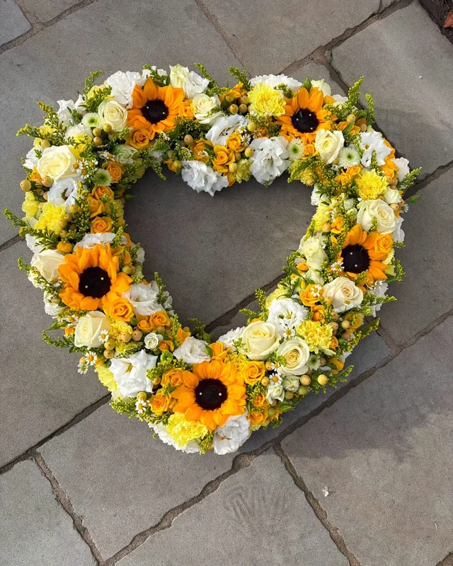 Heart tribute of sunflowers, roses and white chrysanthemums